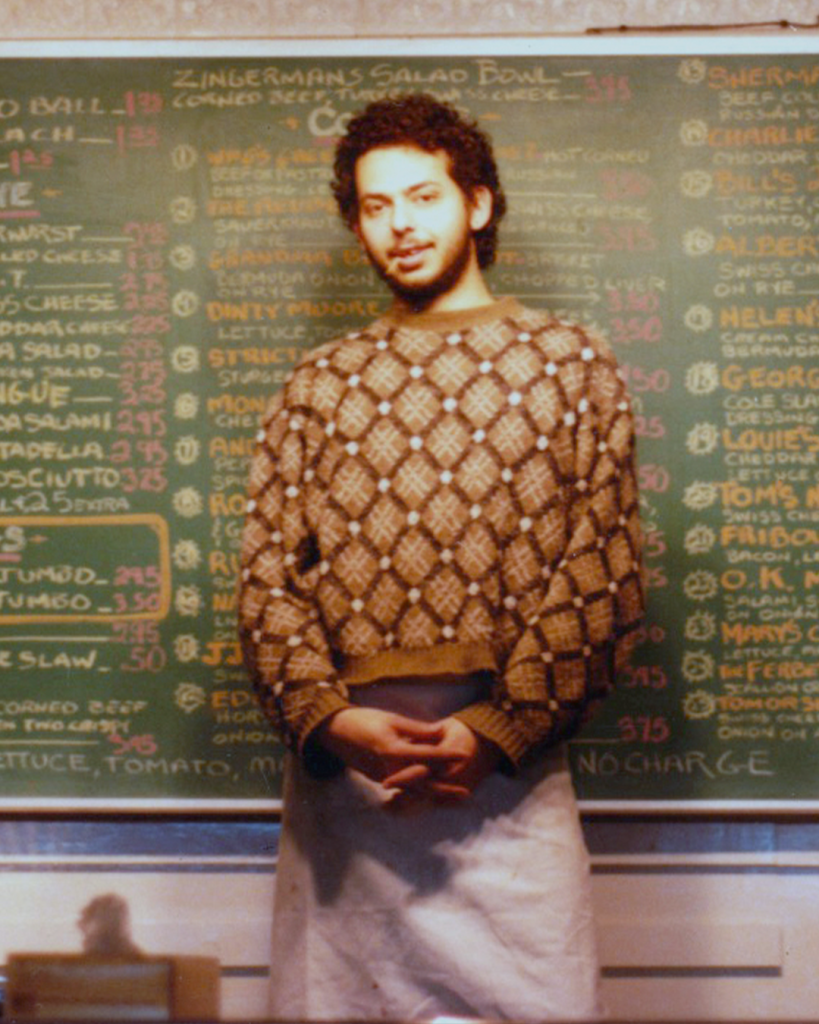 Ari in front of a chalkboard